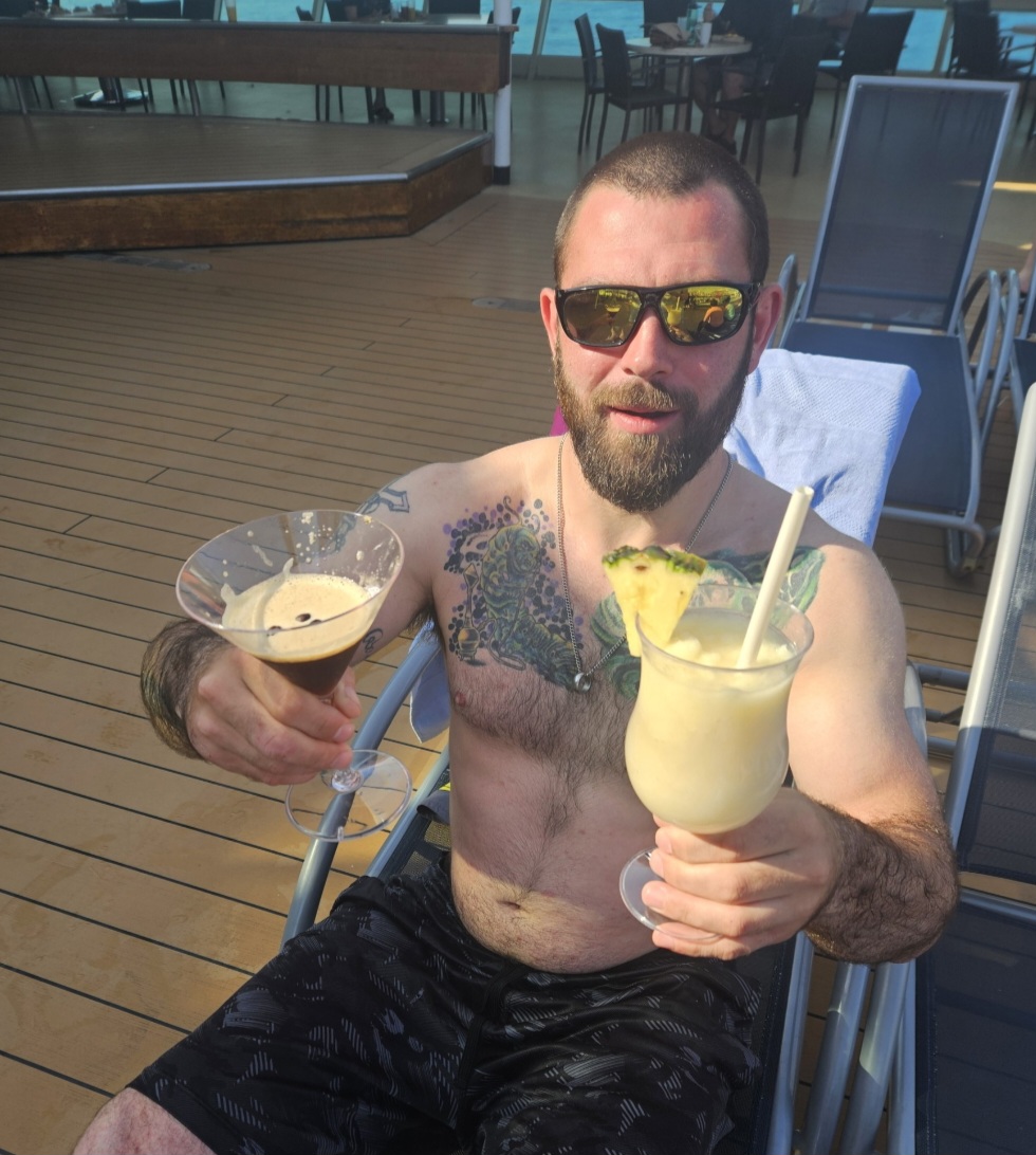 a man and a woman sitting next to a swimming pool