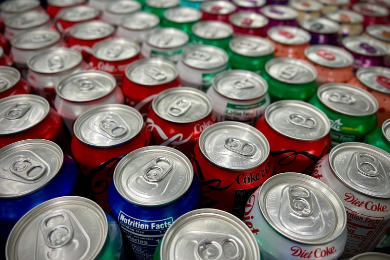 a large group of cans of soda