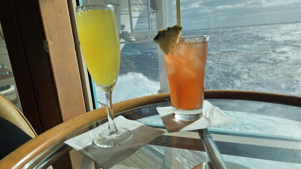 Cocktails by the window with an ocean view on Vision of the Seas